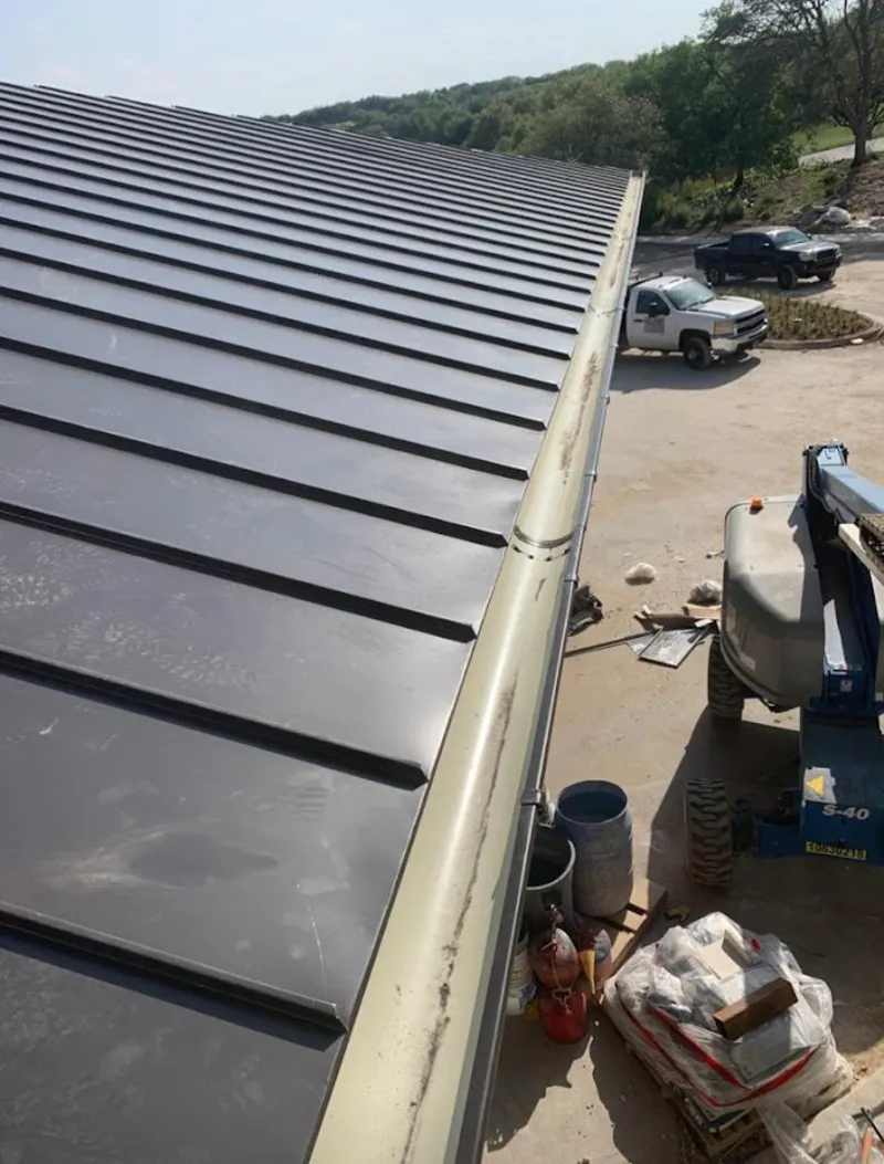Standing seam panel and gutter detail on a metal roofing jobsite in Holland